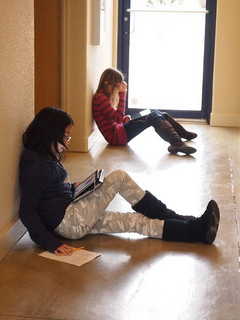 Children in hallway reading from their iPads
